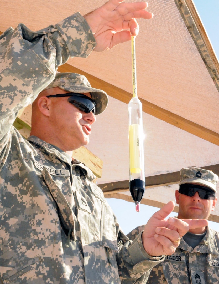 U.S. Army Staff Sgt. Garold Pennell, a petroleum supply specialist and assistant to the responsible officer at Camp Buehring Tactical Petroleum Terminal, 38th Sustainment Brigade, explains the use of a hydrometer at Camp Buehring, Kuwait, Nov. 1, 2012.