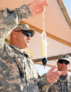 U.S. Army Staff Sgt. Garold Pennell, a petroleum supply specialist and assistant to the responsible officer at Camp Buehring Tactical Petroleum Terminal, 38th Sustainment Brigade, explains the use of a hydrometer at Camp Buehring, Kuwait, Nov. 1, 2012.