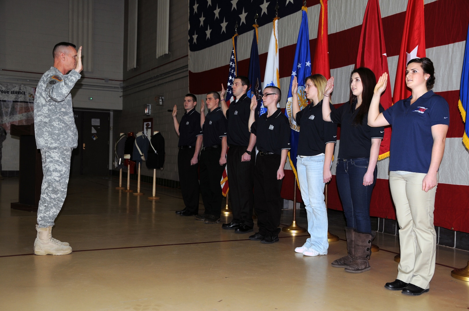 Maj. Gen. Patrick Murphy, the adjutant general of New York, administers the oath of enlistment to six new New York Army National Guard recruits and one new member of the New York Air National Guard during a birthday ceremony held Dec. 13, 2012.