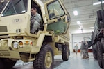 A Soldier at the Sussex, Wis., National Guard armory readies a light medium tactical vehicle for use during a major snowstorm that hit Wisconsin on Dec. 19, 2012. 