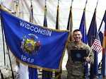 Sgt. Luis Cortes-Avila holds both the Wisconsin and U.S. flags in Bagram, Afghanistan on Nov. 2, 2012, after taking his oath of citizenship.
