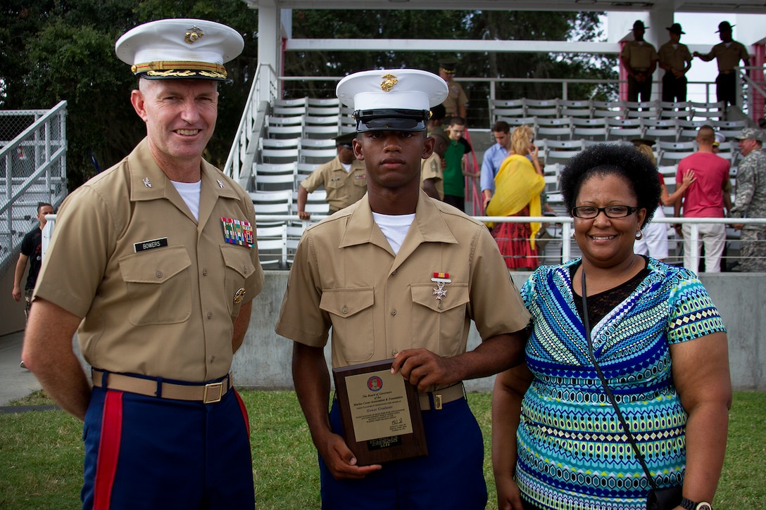 Pfc. Scott Iles, honor graduate of platoon 2069, stands with Col. William Bowers, commanding officer of 6th Marine Corps District, and his grandmother after graduation aboard Parris Island, S.C., Aug. 30, 2013. Iles, native of Pineville, La., was recruited from Recruiting Substation Alexandria, Recruiting Station Baton Rouge, by Sgt. Richard Snelling. Iles will be able to enjoy some much deserved leave with his family and prepare for Marine Combat Training at Camp Geiger, N.C. (U.S. Marine Corps photo by Lance Cpl. John-Paul Imbody)