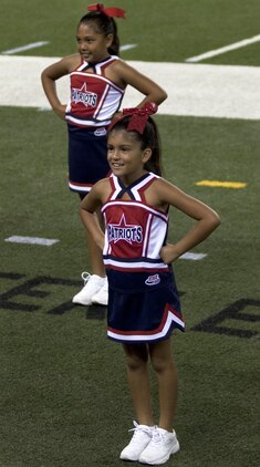 Marine Corps Base Hawaii’s Pop Warner tackle-football team’s cheerleaders cheer on the Patriots while they play against the Waianae Tigers at Aloha Stadium, Aug. 24, 2013. (U.S. Marine Corps photo by Lance Cpl. Janelle Y. Chapman)

