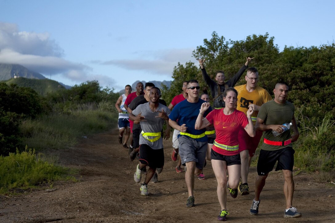 Marines show their enthusiasm while running in the 101 Days of Summer Nuupia Ponds Fun Run, Aug. 28, 2013. The run was the last event in the 101 Days of Summer Program which promotes a healthy lifestyle and summer safety. Units competed in several sports tournaments during the season. (U.S. Marine Corps photo by Lance Cpl. Janelle Y. Chapman)