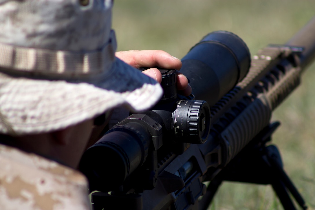 Sgt. Andrew Piesch, a recon Marine with third platoon, Force Reconnaissance Company, 13th Marine Expeditionary Unit, I Marine Expeditionary Force, adjusts the sights on his scope during a live-fire high-angle sniper exercise at Kaneohe Bay Range Training Facility aboard Marine Corps Base Hawaii, Aug. 23, 2013. (U.S. Marine Corps photo by Lance Cpl. Matthew Bragg)