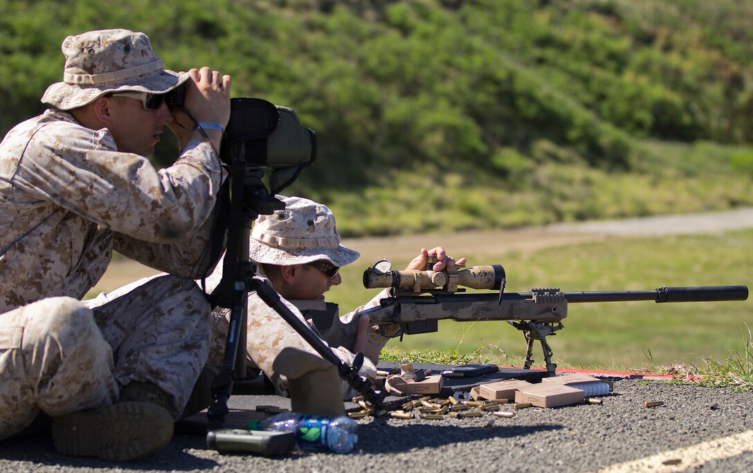 A sniper and his spotter, both recon Marines with third platoon, Force Reconnaissance Company, 13th Marine Expeditionary Unit, I Marine Expeditionary Force, complete a live-fire high-angle sniper exercise at Kaneohe Bay Range Training Facility aboard Marine Corps Base Hawaii, Aug. 23, 2013. The relationship between a sniper and his spotter is an important one, because they rely on each other to ensure the mission is accomplished. (U.S. Marine Corps photo by Lance Cpl. Matthew Bragg)