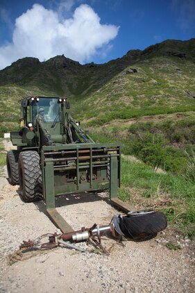 A piece of landing gear from a World War II-era patrol bomber aircraft is removed from Kaneohe Bay Range Training Facility aboard Marine Corps Base Hawaii, Aug. 20, 2013. Range and Training Area Management joined Coral Rasmussen, a base archeologist/cultural resource manager, to work with aviation archeologist David Trojan of the Travis Heritage Center to complete the collection and cataloguing the remainder of World War II-era aircraft surface artifacts located at K-Bay Range. Because of this, Marines have more flexibility to train in different areas of the Ulupau crater without hazards. One area that was cleared of material is now being used as a point-man course for infantry Marines, enhancing the utility of the range. (U.S. Marine Corps photo by Cpl. Matthew Callahan)