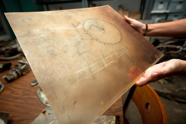 David Trojan, an aviation archeologist with the Travis Heritage Center, shows a World War II-era plotting chart recovered at the Kaneohe Bay Range Training Facility, Marine Corps Base Hawaii, Aug. 20, 2013. Trojan worked with Range and Training Area Management and Coral Rasmussen, an archeological/cultural resource manager, to wrap up the recovery of the WWII-era aviation artifacts. (U.S. Marine Corps photo by Cpl. Matthew Callahan)