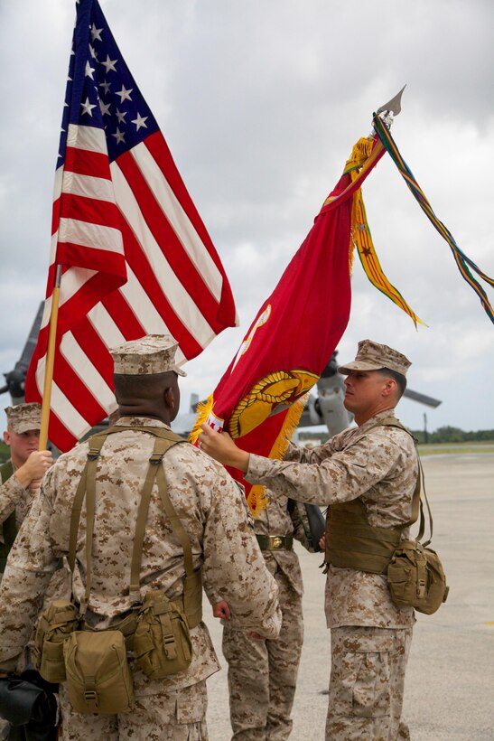 Lt. Col. Larry G. Brown, right, adjusts the Marine Medium Tiltrotor Squadron 262 unit colors Aug. 30 during a redesignation ceremony at Marine Corps Air Station Futenma. The squadron, previously Marine Medium Helicopter Squadron 262, was redesignated to reflect the replacement of the squadron's CH-46E Sea Knight helicopters with MV-22B Osprey tiltrotor aircraft.  “As we begin the next chapter and continue our transition from good to great, how we do things will continue to change, but why we do them and who we are shall remain,” said Brown during the ceremony. VMM-262 is a part of Marine Aircraft Group 36, 1st Marine Aircraft Wing, III MEF.  Brown is the commanding officer of VMM-262. 