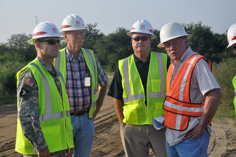 JASPER COUNTY, S.C.—Work continues at the U.S. Army Corps of Engineers Savannah Harbor dredge disposal area "12A" shown here Aug. 27, 2013. Col. Thomas Tickner (right), commander for the Corps' Savannah District, and his staff visit the work site and meet with David Snodgrass (far right), a quality control manager from Edgefield Construction, the prime contractor for the 12A improvement project. Next to Tickner are William Lane and Burt Moore of the Corps' Savannah District operations division.