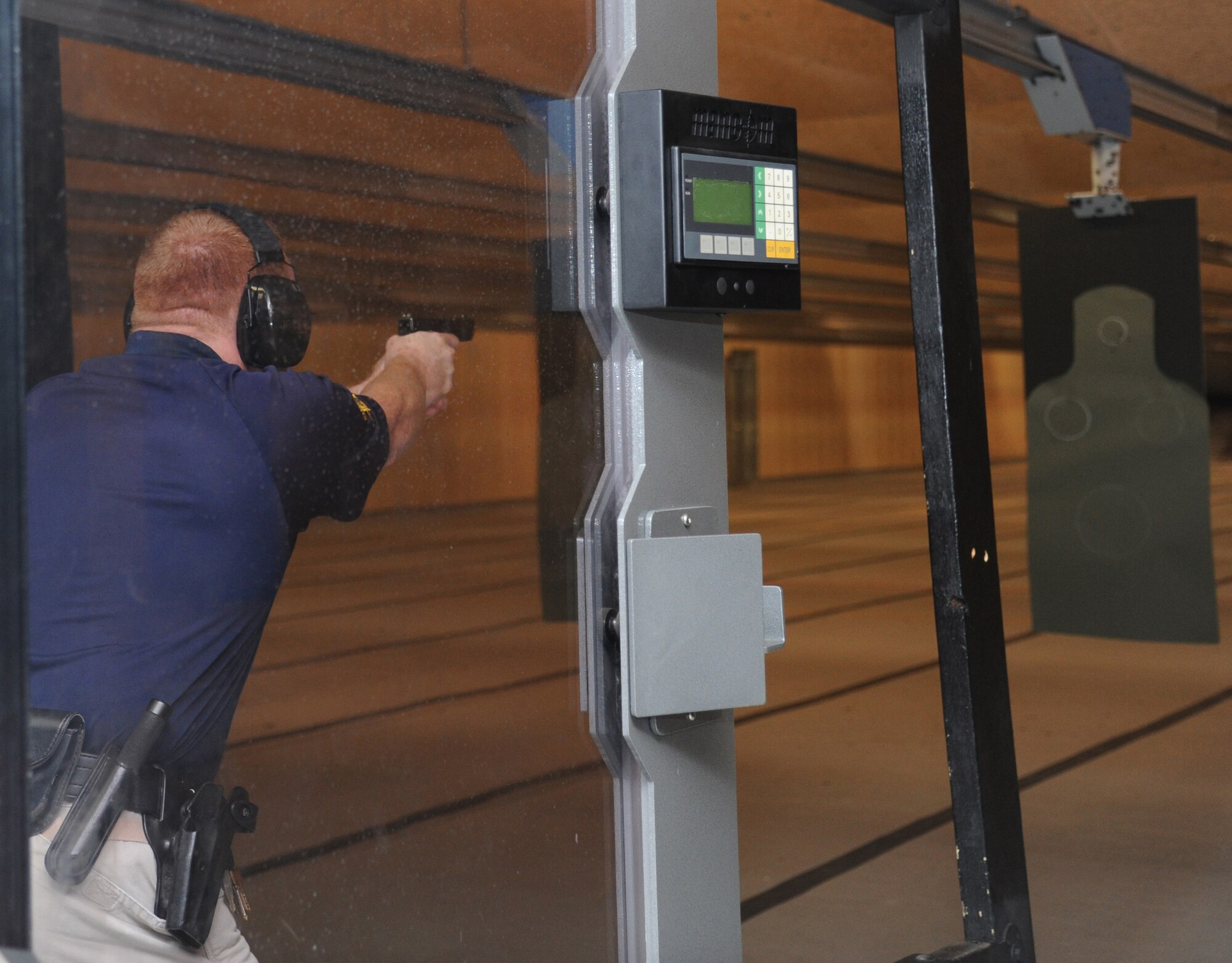 Sergeant Glen Powell, Harrison County Sheriff’s Department, fires at a target during the second annual Air Force Office of Special Investigations and the 81st Security Forces Squadron’s pistol shoot-off competition  Aug. 30, 2013, at the indoor firing range, Keesler Air Force Base, Miss.  Nine five-man teams from local law enforcement agencies competed in the event.  (U.S. Air Force photo by Kemberly Groue)
