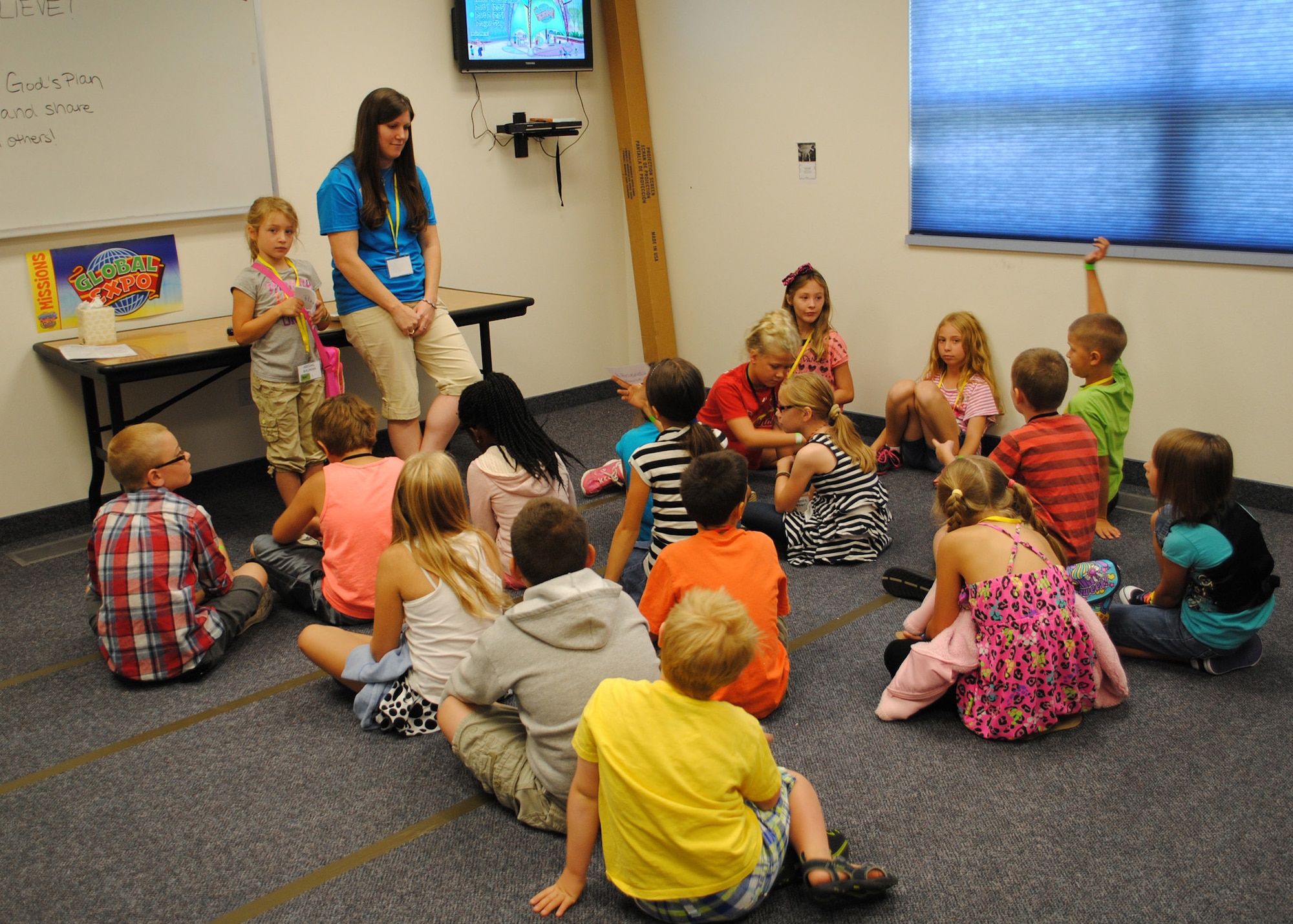 Children take turns answering questions about missionaries during a class at Vacation Bible School on Aug. 20.  Children were split up by age to create groups that rotated through various activities during VBS.  (U.S. Air Force photo/Senior Airman Cortney Paxton)