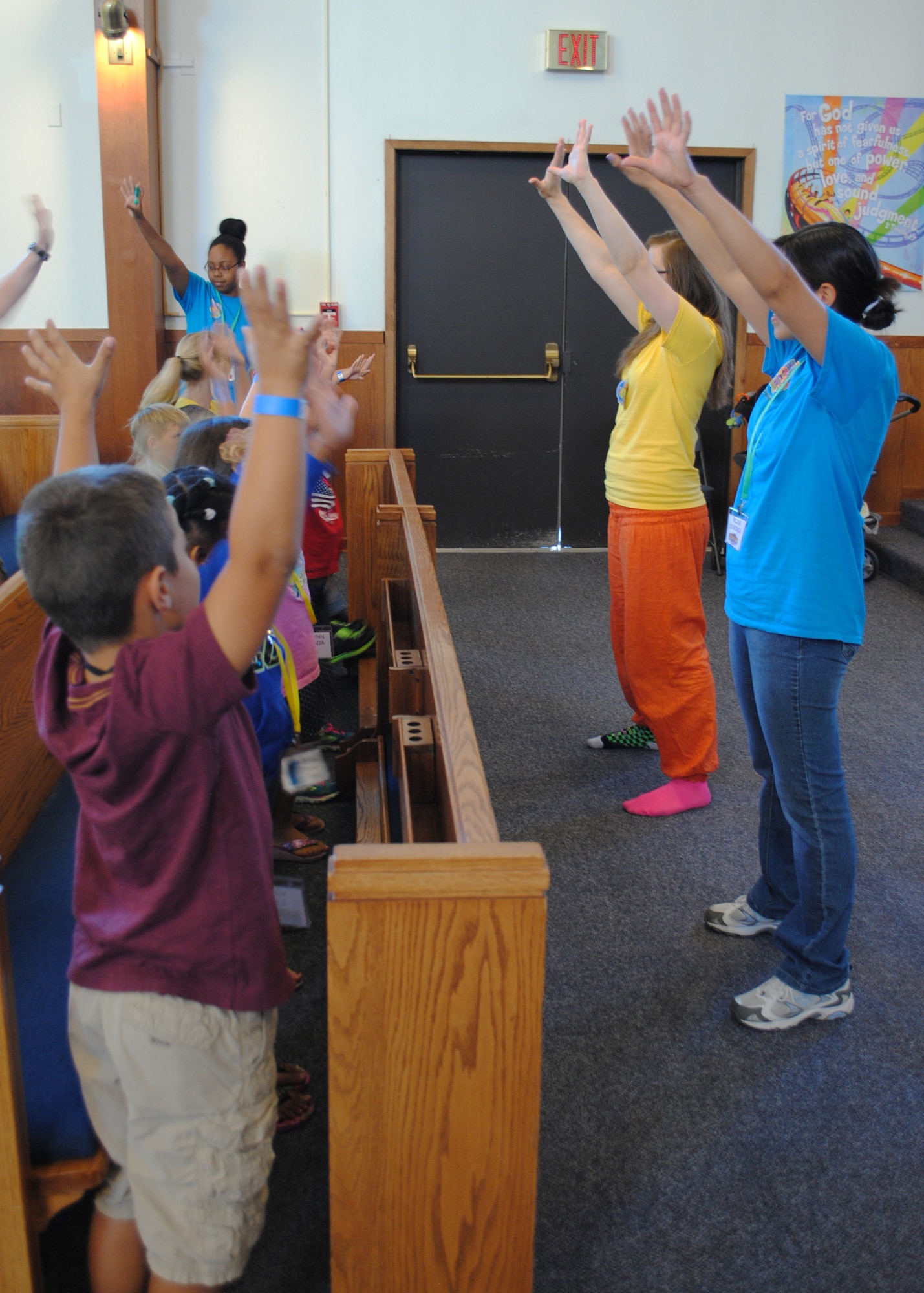 Volunteers at Malmstrom’s Vacation Bible School teach children hand signals to accompany songs sung at the week-long school Aug. 19 through 23 at the base chapel.  Nearly 100 children signed up to attend this year’s VBS. (U.S. Air Force photo/Senior Airman Cortney Paxton)