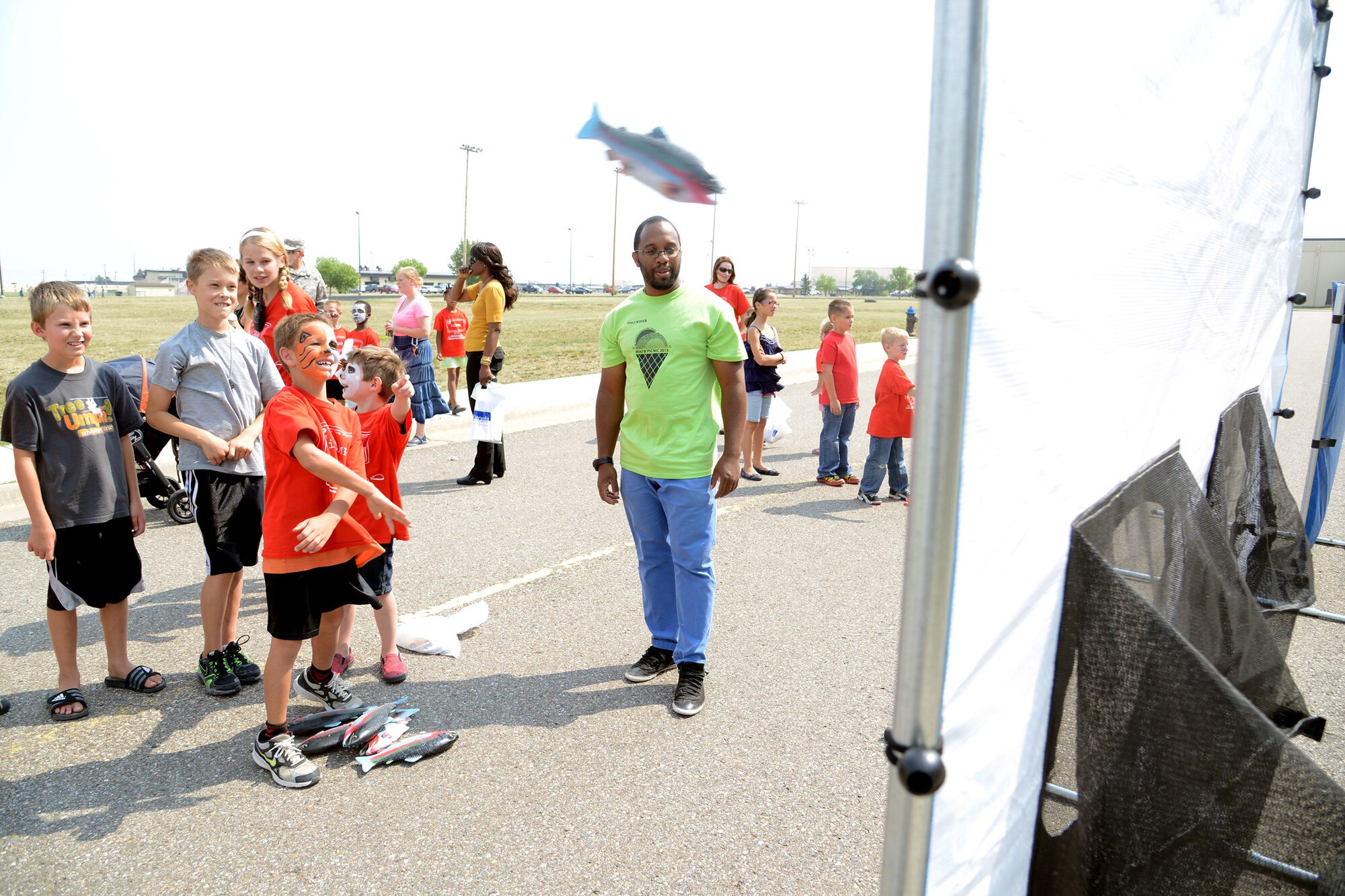 Children take turns trying to throw a plastic fish into a round net at the annual Malmstrom Air Force Base picnic Aug. 23 at Sun Plaza Park. Several games were set up for kids to enjoy during the event. (U.S. Air Force photo/Staff Sgt. R.J. Biermann) 
