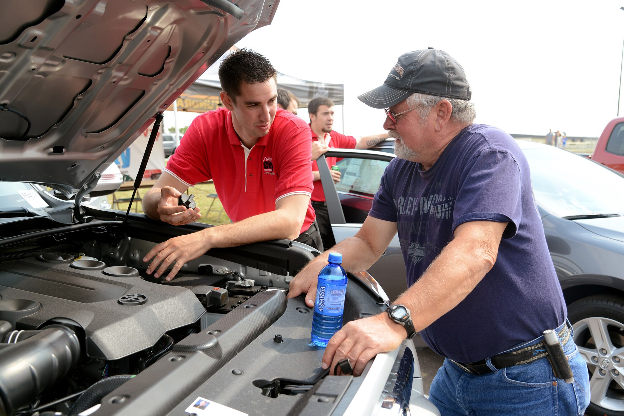 James Furst, a City Toyota sales representative, shows Hank Wilczek, a retiree, under the hood of a Toyota 4Runner during the annual Malmstrom Air Force Base picnic Aug. 23 at Sun Plaza Park. Several new vehicles from numerous local dealerships were on display, as were several oldies, during a car show at the picnic. (U.S. Air Force photo/Staff Sgt. R.J. Biermann) 