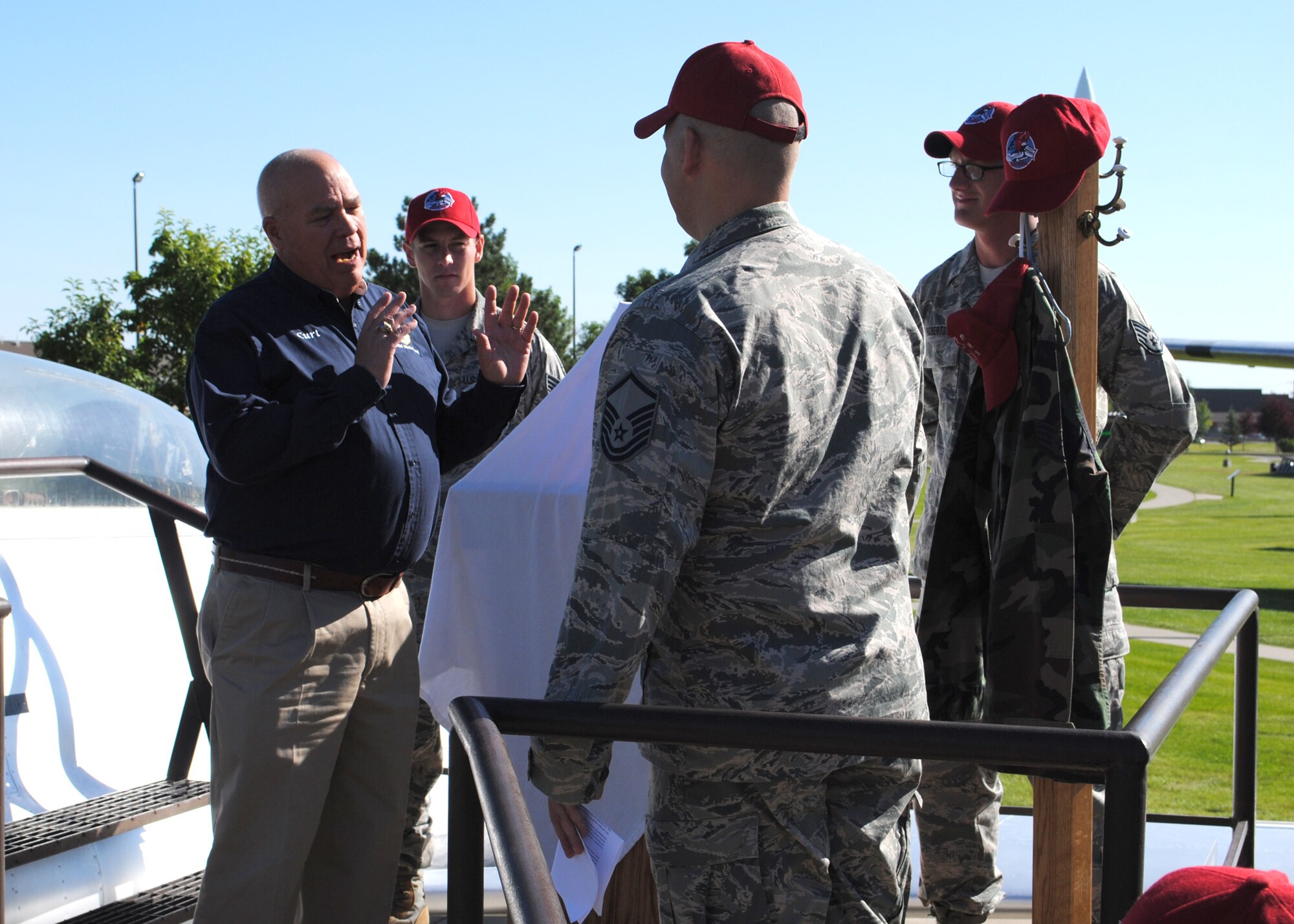 Curt Shannon, 341st Missile Wing heritage center director, speaks to Master Sgt. Lloyd Ickes, 819th RED HORSE Squadron airfields member, during the presentation of an 819th RHS legacy item Aug. 20.  The legacy item, an 819th RHS uniform, along with an 819th RHS red horse statue was presented to Shannon to be displayed at the Malmstrom Museum.  (U.S. Air Force photo/Senior Airman Cortney Paxton)