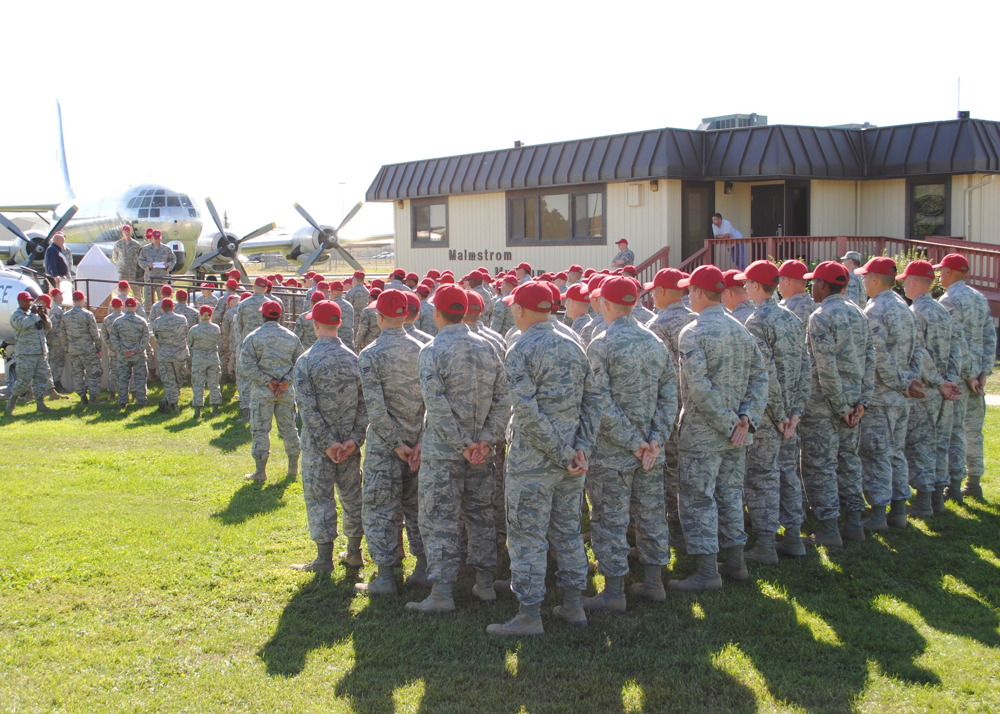 A group of Malmstrom’s 819th RED HORSE Squadron Airmen stand in formation as others gather around a display outside of the Malmstrom Museum during the presentation of an 819th RHS uniform to be displayed at the museum.  Following the presentation, 819th RHS members gathered at Sun Plaza Park for a “birthday bash” in honor of the squadron’s reactivation at Malmstrom Air Force Base 16 years ago on Aug. 7.  (U.S. Air Force photo/Senior Airman Cortney Paxton)