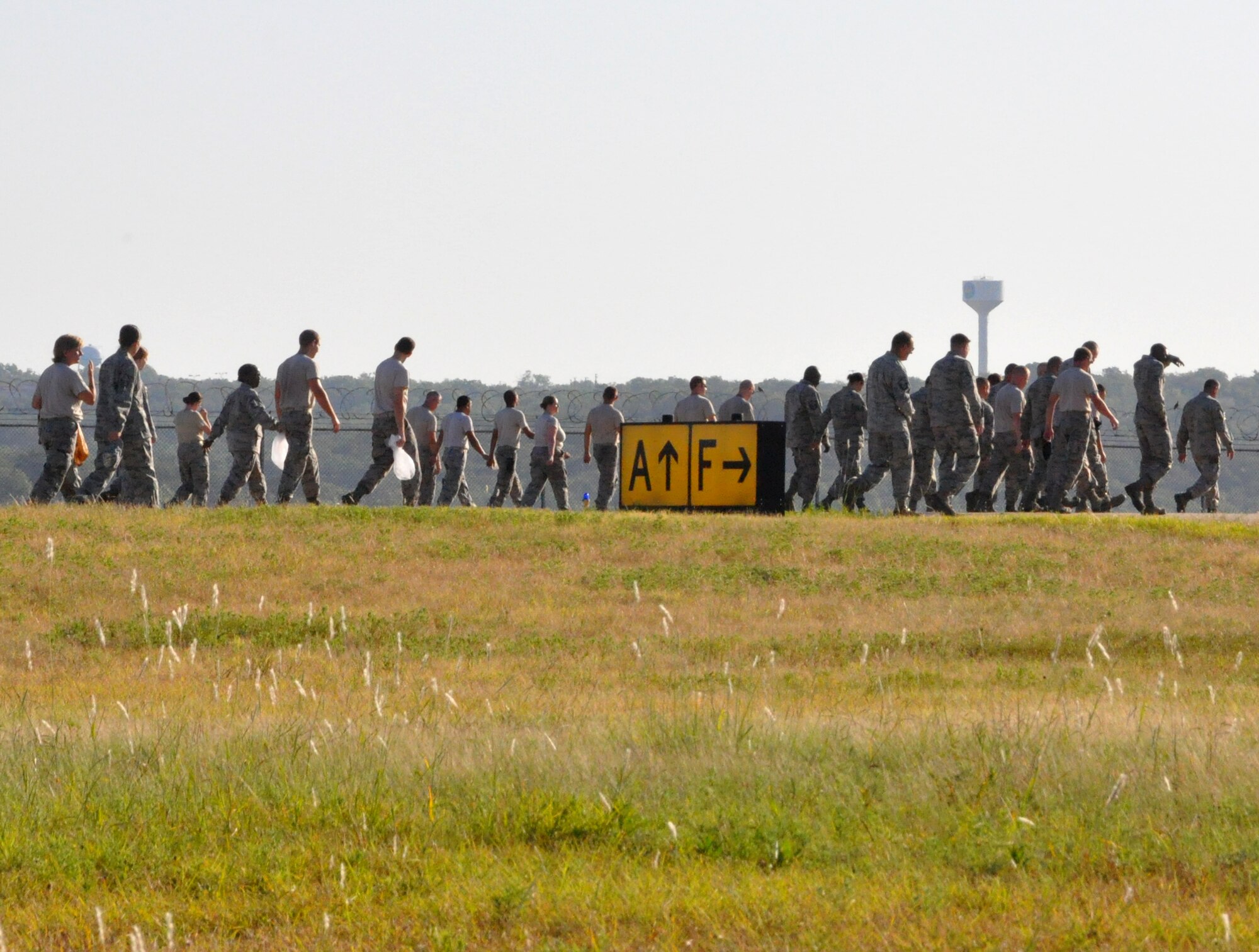 Air Reserve and Air National Guardsmen join in the Naval Air Station Fort Worth Joint Reserve Base Foreign Object Debris (FOD) walk August 29 prior to aircraft returning to the base. FOD creates safety hazards and can ultimately impact safe operations by damaging aircraft. All NAS JRB aircraft were based out of Alliance Airport while the runway received a makeover for the first time in about ten years. Aircraft and support personnel are schedule to return by the end of August. (U.S. Air Force photo/Master Sgt. Julie Briden-Garcia)