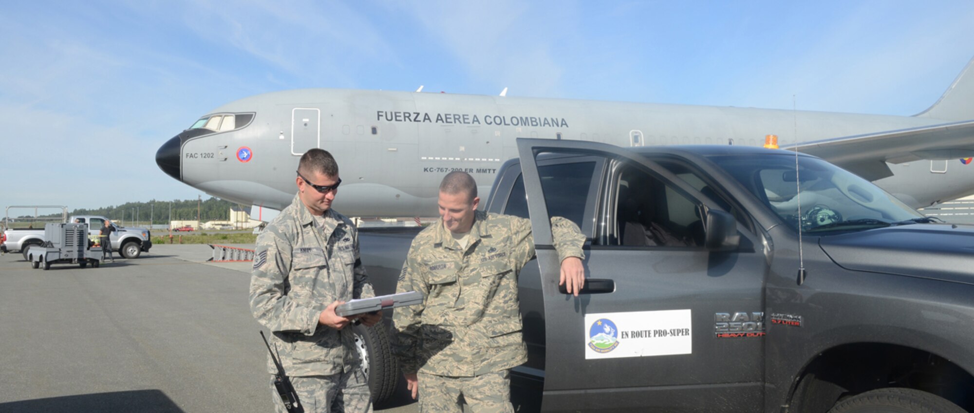 Members of the 732d Air Mobility Squadron assist a Colombian Air Force Boeing 767 Aircraft after it emergency landed at Joint Base Elmendorf-Richardson early Saturday morning. (U.S. Air Force photo/Amn Ty-Rico Lea)