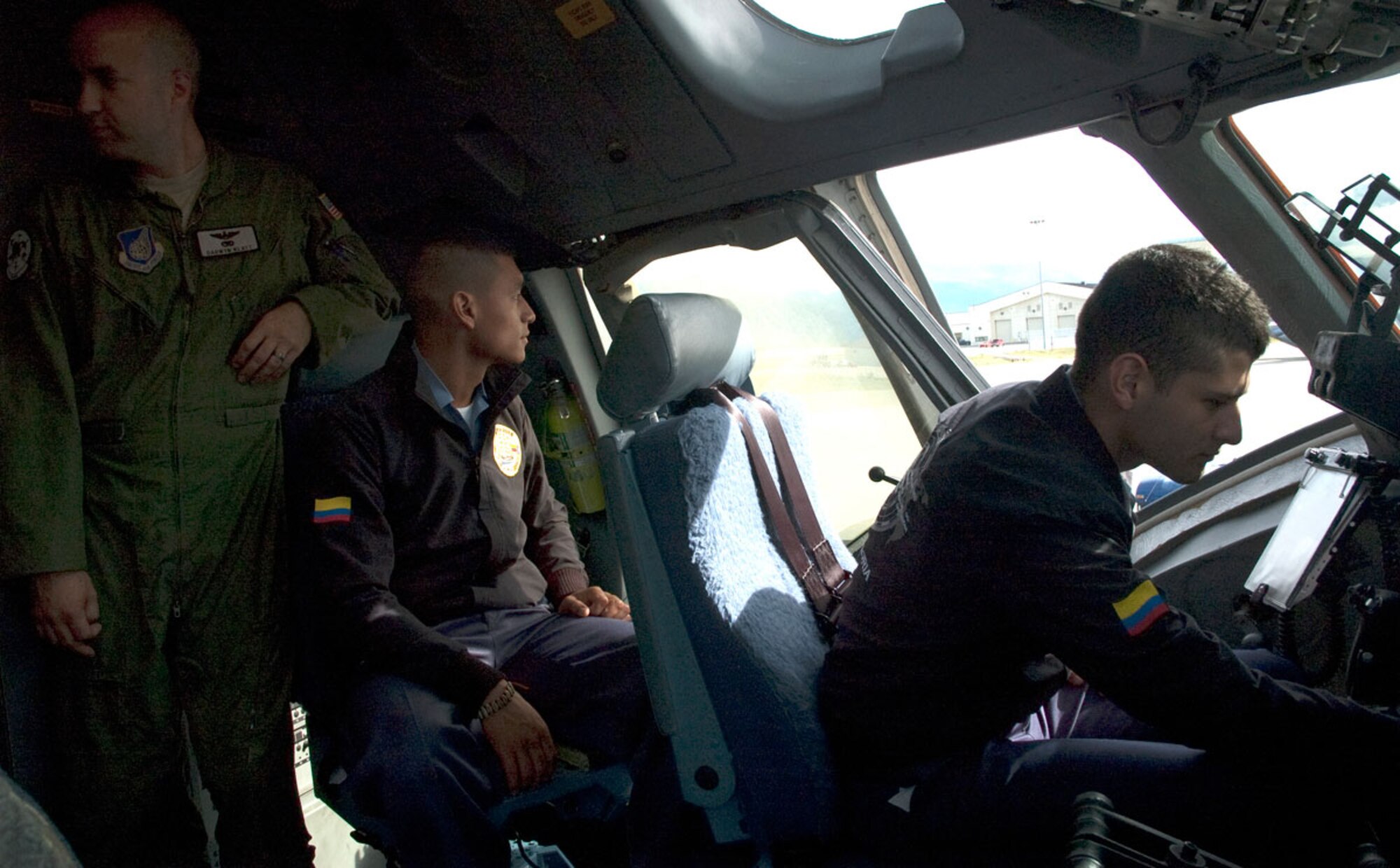 Cadets from the Colombian Naval Academy experience the cockpit of a C-17 aircraft while Maj. Darwyn Klatt, pilot with the 517th Airlift Squadron, looks on. (U.S. Air Force photo/2nd Lt Michael Harrington)