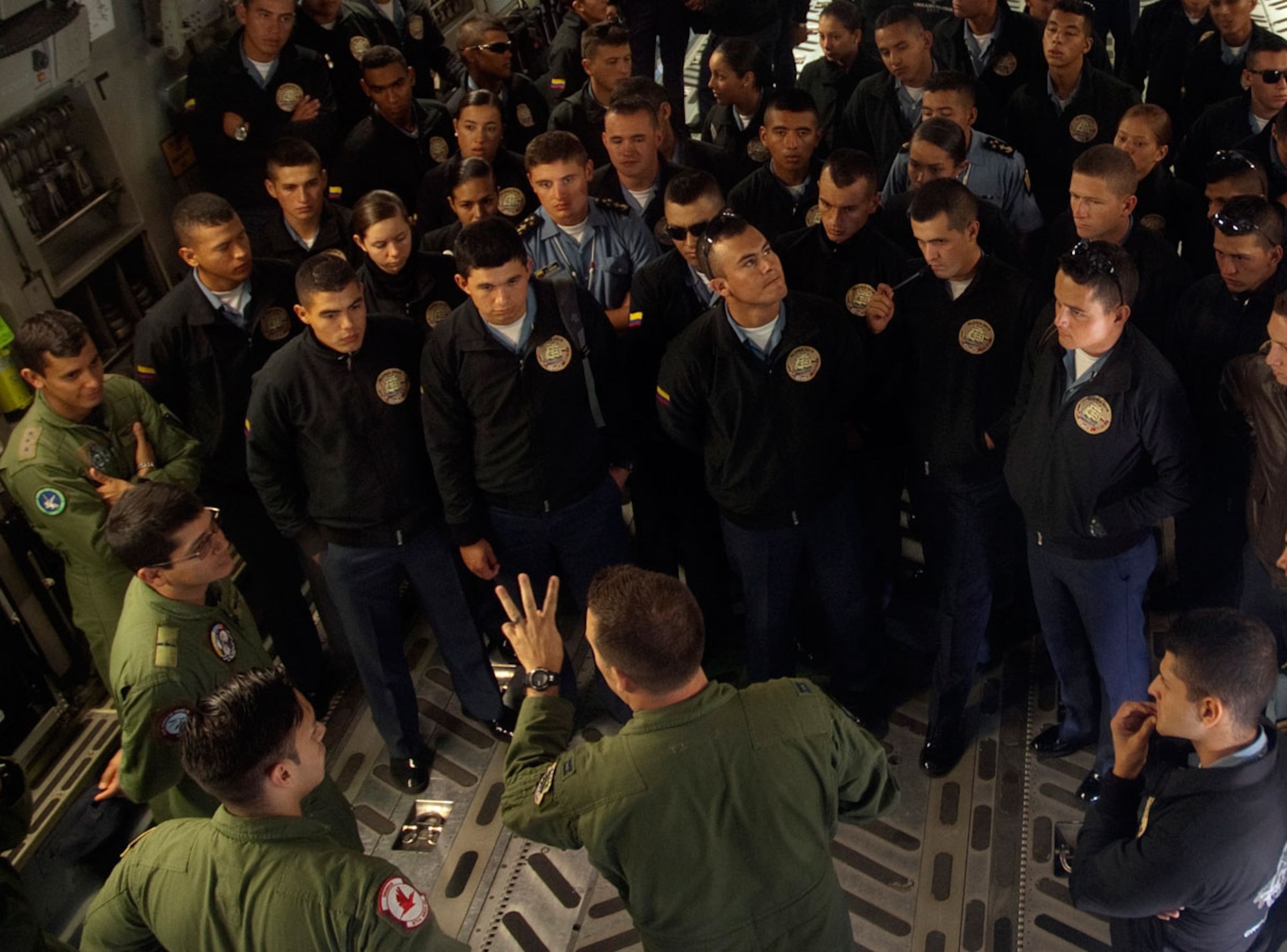Colombian Naval Academy cadets and Colombian Air Force officers watch as members of the 517th Airlift Squadron describe the capabilities of the C-17 aircraft. (U.S. Air Force photo/2nd Lt Michael Harrington)