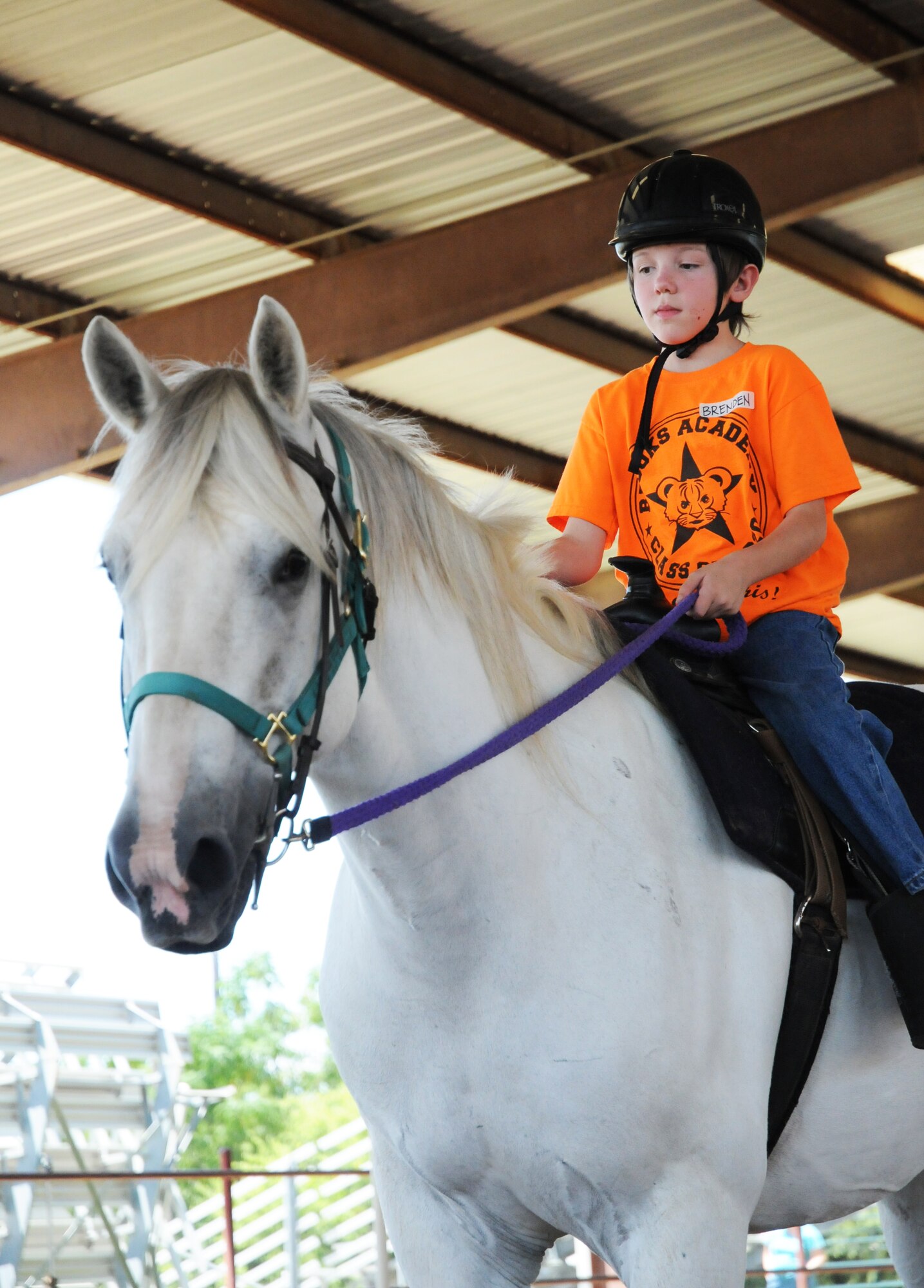 Brenden Hoopes, an Exceptional Family Member Program athlete, participates in 
an exercise to improve coordination during a Special Olympics equestrian camp 
Aug. 13 at the Joint Base San Antonio-Fort Sam Houston Equestrian Center. (U.S. Air Force photo by Airman 1st Class Alexandria Slade)
