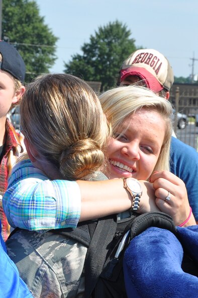 Members of the 80th Aerial Port Squadron are welcomed home by family and friends from a six-month deployment to Southwest Asia Aug. 27. The aerial porters served a critical role in the delivery of cargo and personnel in and out of austere and unimproved landing zones. (U.S. Air Force photo/James Branch)