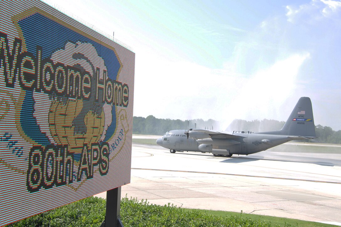 Members of the 80th Aerial Port Squadron return to Dobbins Air Reserve Base from a six-month deployment to Southwest Asia Aug. 27. The crew moved 20,000 tons of cargo and 38,000 passengers over 1,500 sorties and provided mobility training to civilians and military members of the host countries. (U.S. Air Force photo/James Branch)