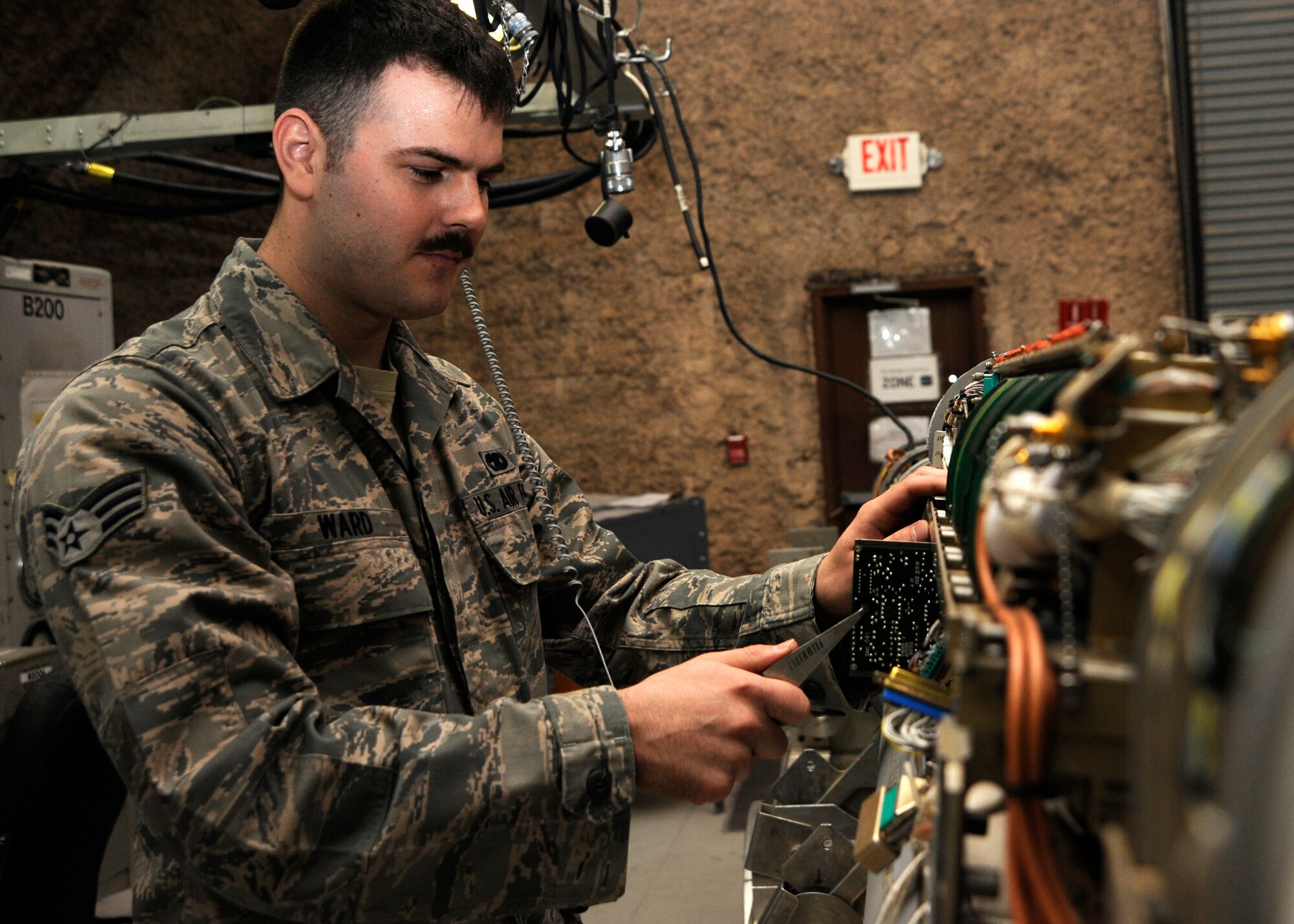 Senior Airman Shawn Ward pulls a circuit card out of an electronic countermeasure pod during troubleshooting at the 379th Air Expeditionary Wing in Southwest Asia, Aug. 26, 2013. Ward is a 379th Expeditionary Maintenance Squadron ECM team member deployed from Shaw Air Force Base, S.C., and hails from Houston, Texas. (U.S. Air Force photo/Senior Airman Bahja J. Jones) 