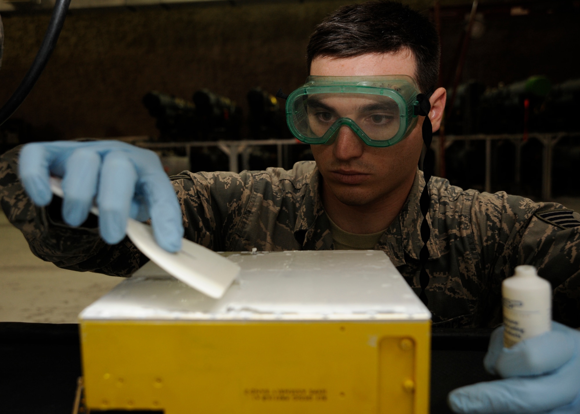 Staff Sgt. Daniel Felice applies heat sink to a high voltage power supply, which help cool the electronics within the electronic countermeasure pod at the 379th Air Expeditionary Wing in Southwest Asia, Aug. 26, 2013. Felice is a 379th Expeditionary Maintenance Squadron electronic counter measure team leader deployed from Spangdahlem Air Base, Germany, and a Chula Vista, Calif., native. (U.S. Air Force photo/Senior Airman Bahja J. Jones) 