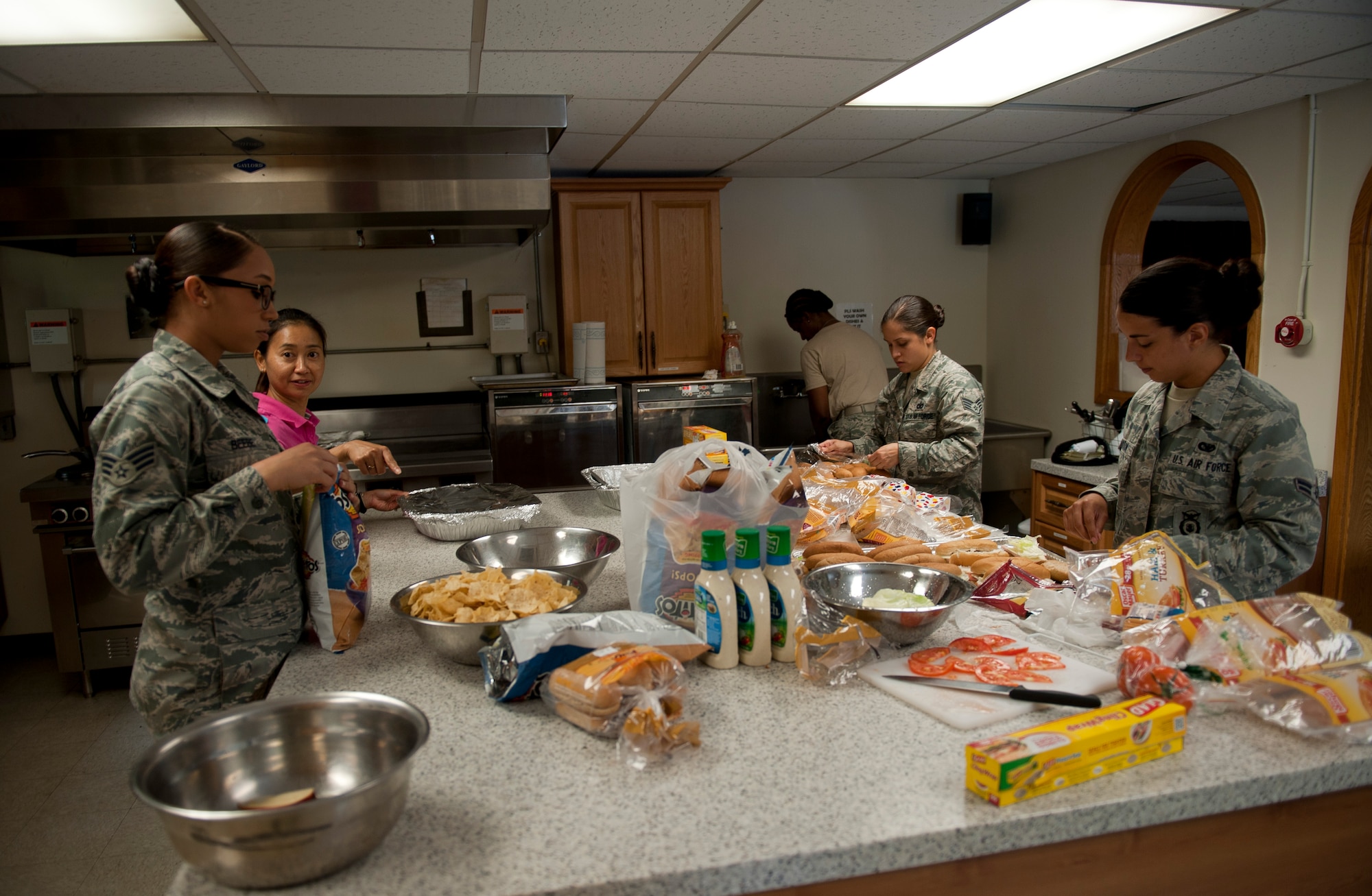 Volunteers prepare food for the Women's Equality Day luncheon Aug. 26, 2013 at Kunsan Air Base, Republic of Korea. August 26 is the anniversary of the passing of the 19th Amendment, which gave women the right to vote. (U.S. Air Force photo by Senior Airman Clayton Lenhardt/Released)