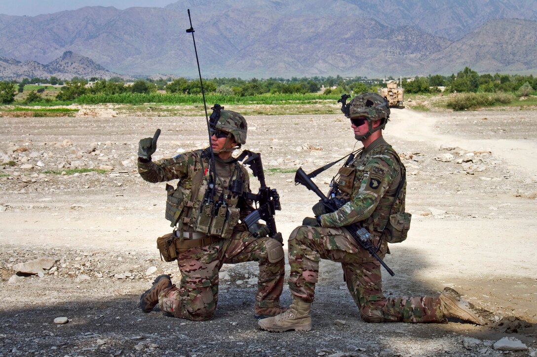 U.S. Army Staff Sgt. Michael D. Vu, left, shows U.S. Army 1st Lt. Andrew B. Pilling where he has soldiers pulling security during a mission in the Saberi district in Afghanistan's Khowst province, Aug. 21, 2013. Vu, an infantryman, and Pilling, a platoon leader, are assigned to the 101st Airborne Division's Company E, 2nd Battlion, 506th Infantry Regiment, 4th Brigade Combat Team.