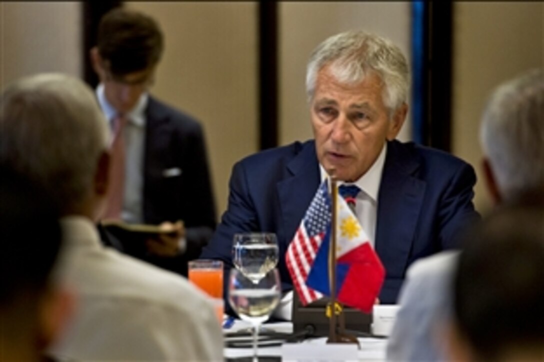 U.S. Defense Secretary Chuck Hagel speaks with Philippine Defense Secretary Voltaire Gazmin and Foreign Secretary Albert F. del Rosario at Malacanang Palace in Manila, Philippines, Aug. 30, 2013. Hagel's visit to the Philippines concludes a four-nation trip to speak with defense counterparts.