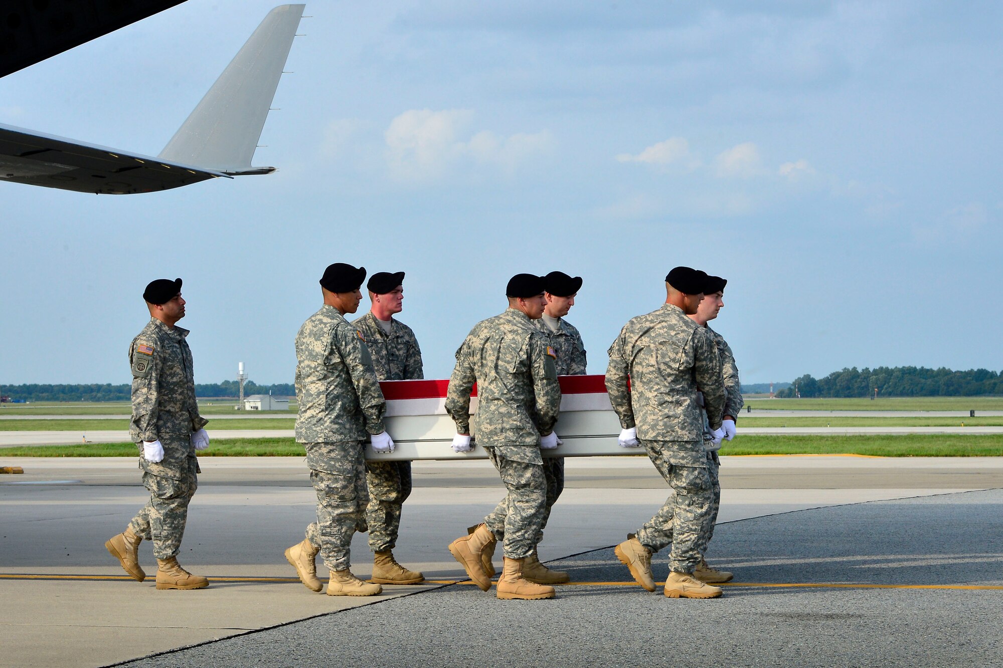 A U.S. Army carry team transfers the remains of Army Staff Sgt. Michael H. Ollis, of Staten Island, N.Y.,  at Dover Air Force Base, Del., August 31, 2013. Ollis was assigned to the 2nd Battalion, 22nd Infantry Regiment, 1st Brigade Combat Team, 10th Mountain Division (Light), Fort Drum, N.Y.
(U.S. Air Force photo/David Tucker)
