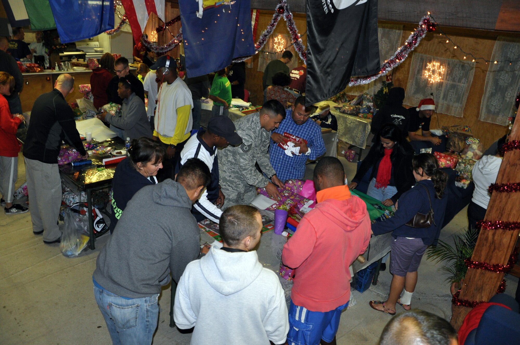 Members of Joint Task Force-Bravo wrap a holiday gifts to be given to local orphans during a gift wrapping party held at Soto Cano Air Base, Honduras, Nov. 30, 2013.  More than 100 volunteers from Joint Task Force-Bravo participated in the event and wrapped more than 300 gifts to be given to the children.  (U.S. Air Force photo by Capt. Zach Anderson)