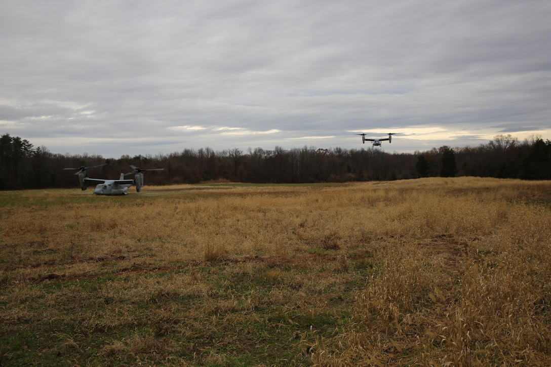 An MV-22 Osprey waits for Marines who are coming from a second Osprey after recovering a downed aircraft during a Tactical Recovery of Aircraft and Personnel mission aboard Marine Corps Base Camp Upshur, Va., November 26. The mission was a scenario during the battalions Alternate Mission Rehearsal exercise in preparation for an upcoming deployment.