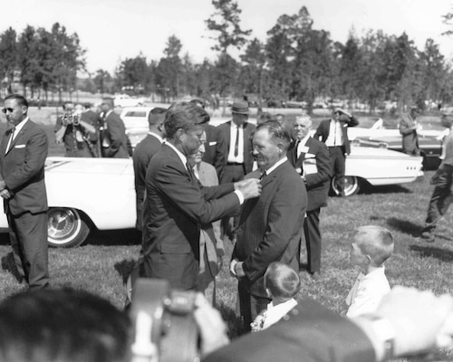 President John F. Kennedy adjusts the tie of Heber Springs Mayor William J. Allbright at the dedication of Greers Ferry Dam Oct. 3, 1963. (photo by USACE Little Rock District)