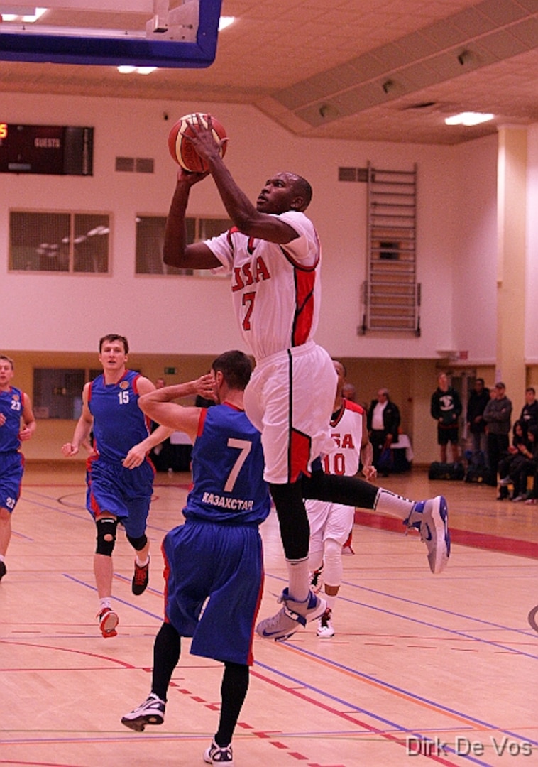 Air Force 2d Lt Mike Lyons (USAFA, CO) drives the lane over his opponent from Kazakhstan during the 2013 SHAPE International Basketball Tournament held at SHAPE (Mons), Belgium 24-30 November.  USA defeated Kazakhstan 104-55.