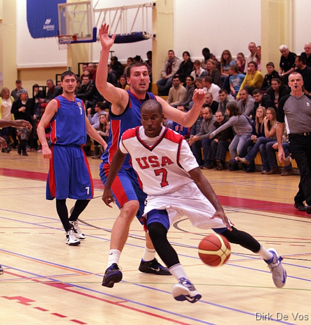 Air Force 2d Lt Mike Lyons (USAFA, CO) gets by his opponent for the score during the 2013 SHAPE International Basketball Tournament held at SHAPE (Mons), Belgium 24-30 November.  USA defeats Kazakhstan 104-55.