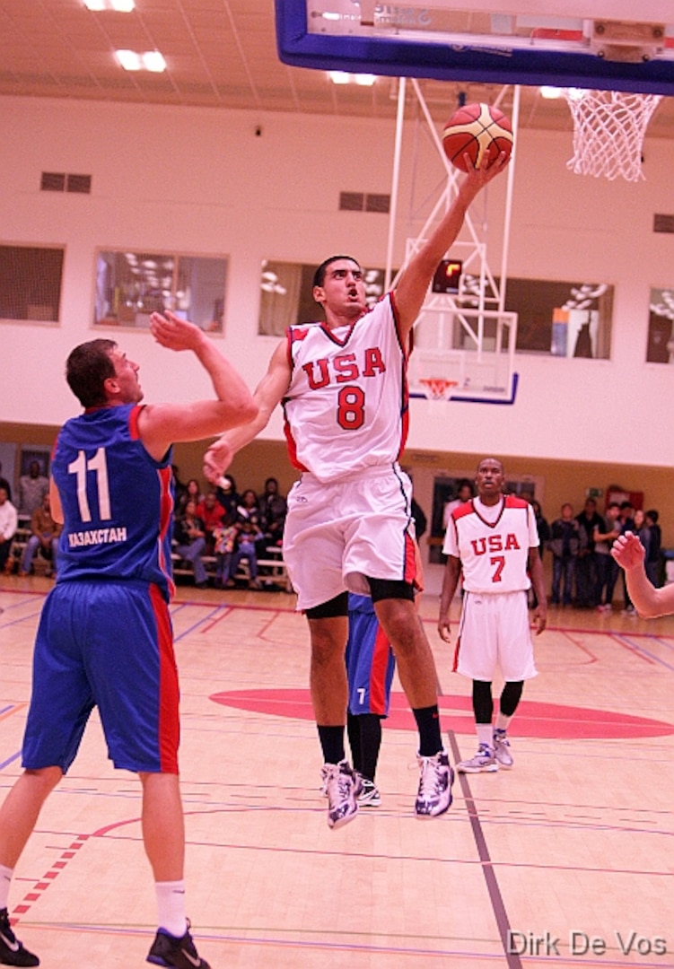 Navy LTJG Romeo Garcia scores over his opponent from Kazakhstan during the 2013 SHAPE International Basketball Tournament held at SHAPE (Mons), Belgium 24-30 November.  USA defeats Kazakhstan 104-55.