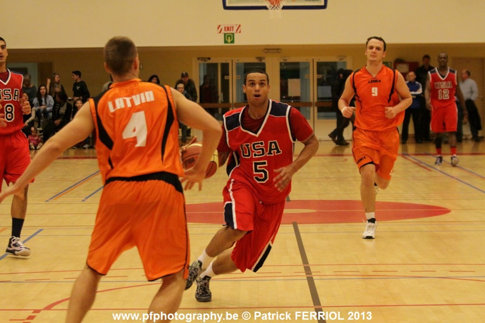 Coast Guardsman FN Marquel DeLancey (USCG Cape May, NJ) blows by his opponent during the 2013 SHAPE International Basketball Tournament held at SHAPE (Mons), Belgium 24-30 November.  USA defeats Latvia 97-73 to win the bronze.