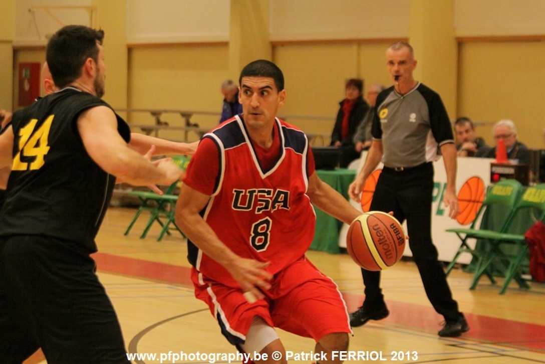 Navy LTJG Romeo Garcia (Norfolk, VA) drives the paint during the 2013 SHAPE International Basketball Tournament held at SHAPE (Mons), Belgium 24-30 November.  USA defeats Belgium 80-31.