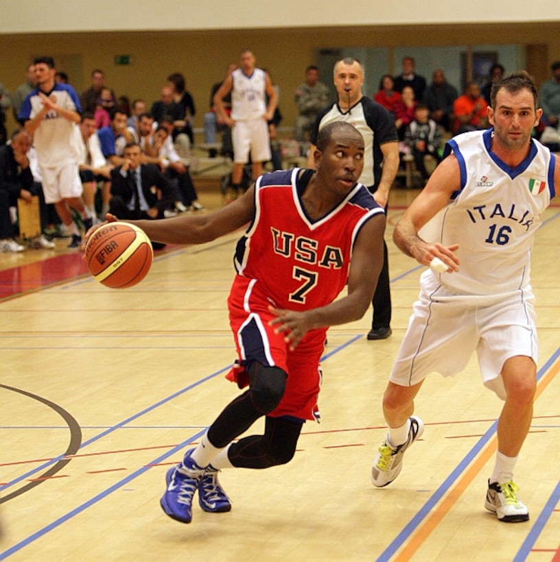 2d Lt Mike Lyons (USAFA, CO) drives to the basket against Italy during the 2013 SHAPE International Basketball Tournament held at SHAPE (Mons), Belgium 24-30 November.  Italy narrowly defeats the US 57-55 in the opening round. 