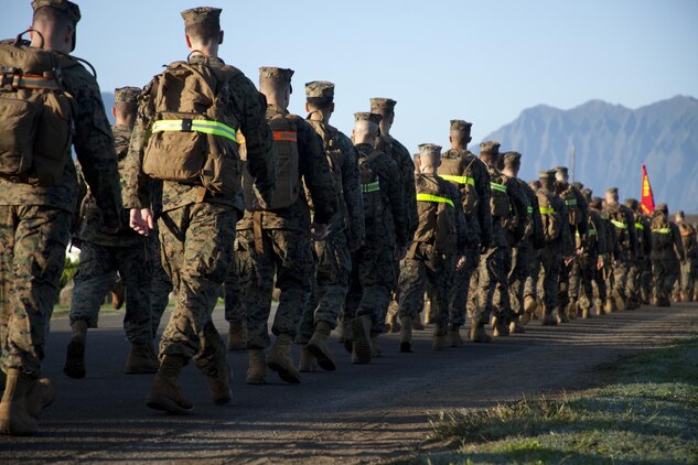 Marines from Headquarters Battalion and Marine Corps Air Station Kaneohe Bay each carry 30 pounds of food in their packs as they march during a 4-mile hike, Nov. 22, 2013. Together the units collected more than 2,000 pounds of food to donate to the Armed Services YMCA. (U.S. Marine Corps photo by Lance Cpl. Janelle Y. Villa)