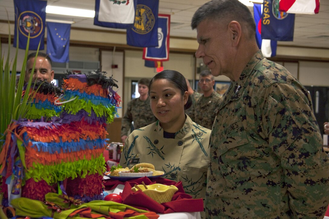 Lance Cpl. Ashly Cerda, food service specialist with Headquarters Battalion and winner of Chef of the Quarter, explains her meal to Maj. Gen. Juan G. Ayala, commanding officer, Marine Corps Installations Command, during the Chef of the Quarter competition at Anderson Hall Dining Facility, Nov. 20, 2013. (U.S. Marine Corps photo by Lance Cpl. Janelle Y. Villa)
