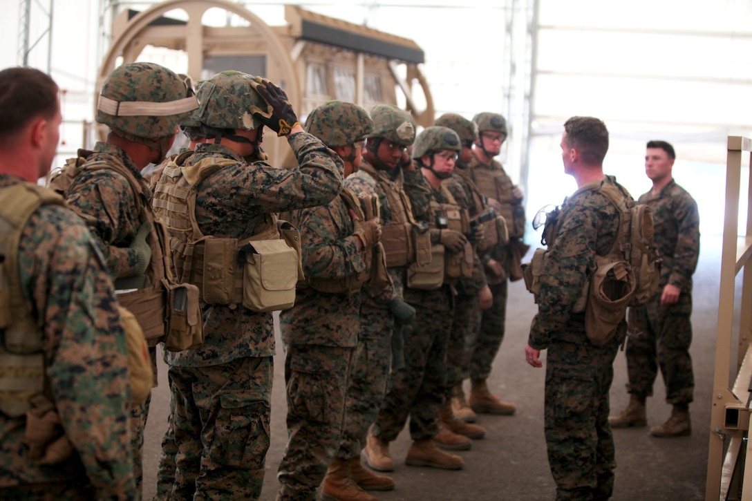 Marines with 1st Air Naval Gunfire Liaison Company line up to for a safety brief before entering the mine-resistant, ambush protected vehicle rollover simulator aboard Camp Pendleton, Calif., Nov. 20, 2013. The simulator is part of Dry Rollover Egress Training that marines undergo prior to deployment.