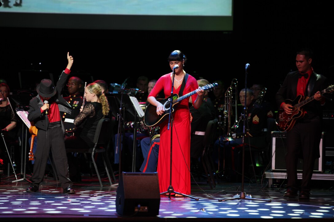 From left, Quinn, Emily and Timi from the Abrigo Ohana perform “Rockin’ Around the Christmas Tree” at the historic Hawaii Theatre here Dec. 1. The Abrigo Ohana was performed for the second time at the U.S. Marine Corps Forces, Pacific Band’s 6th  annual Na Mele o na Keiki (Music for the Children) Holiday Concert.