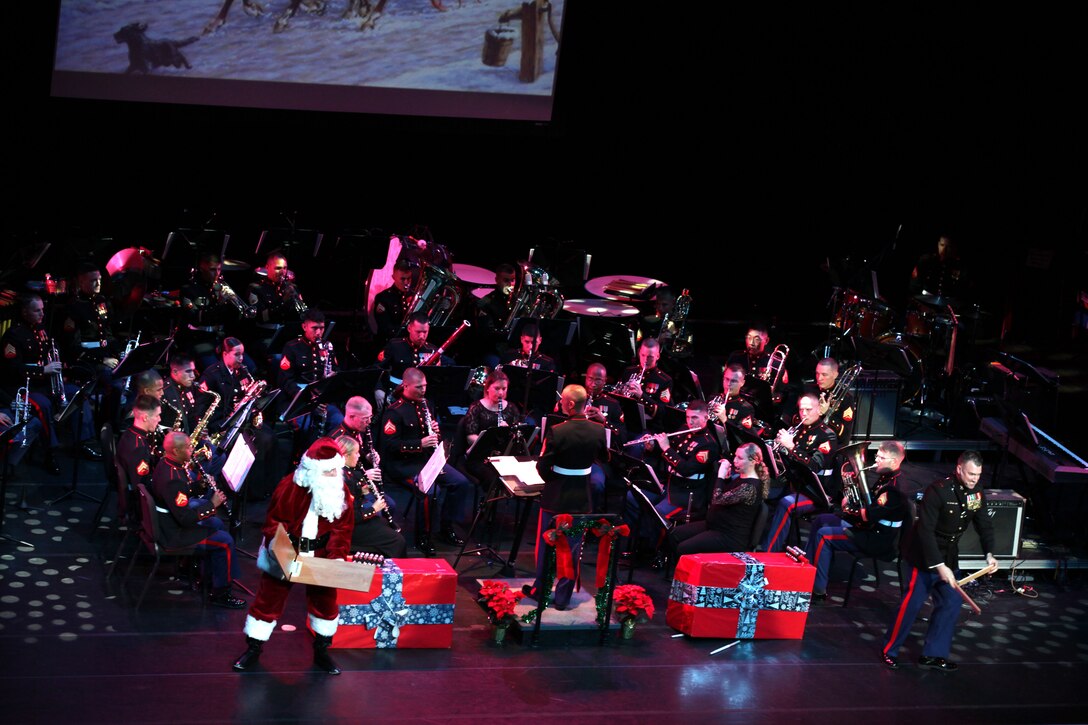Santa Claus and Chief Warrant Officer 3 Michael J. Smith, U.S. Marine Corps Forces, Pacific, the Band Officer, add the whip-crack effects to the song “Sleigh Ride” at the historic Hawaii Theatre here Dec. 1. The MarForPac Band was performing their 6th annual Na Mele o na Keiki (Music for the Children) Holiday Concert.