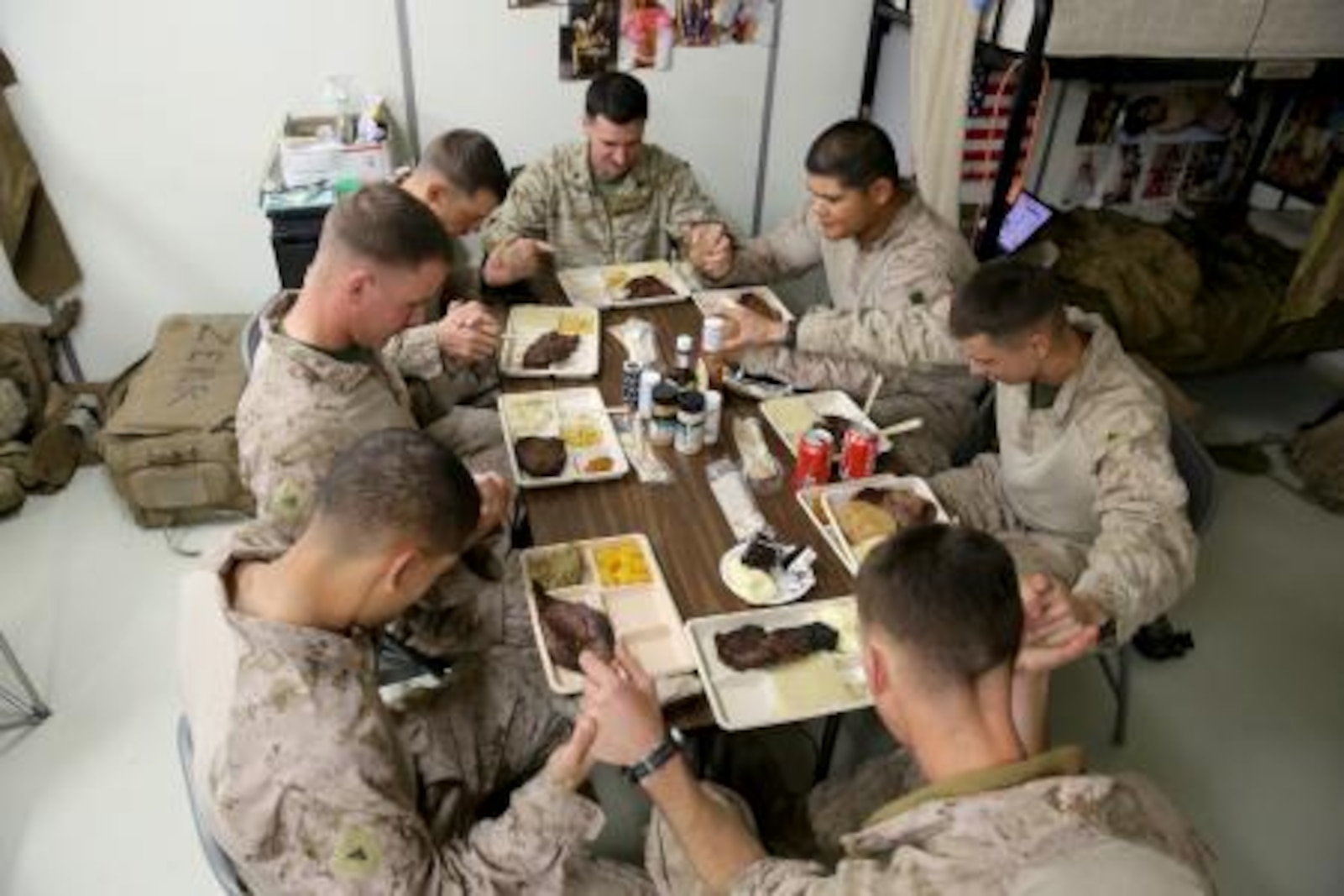 Marines serving with 3rd Battalion, 7th Marine Regiment’s Security Force Assistance Advisor Team, pray before their Thanksgiving dinner here, Nov. 28. The Marines used the holiday meal as a time to share their family traditions with one another.


