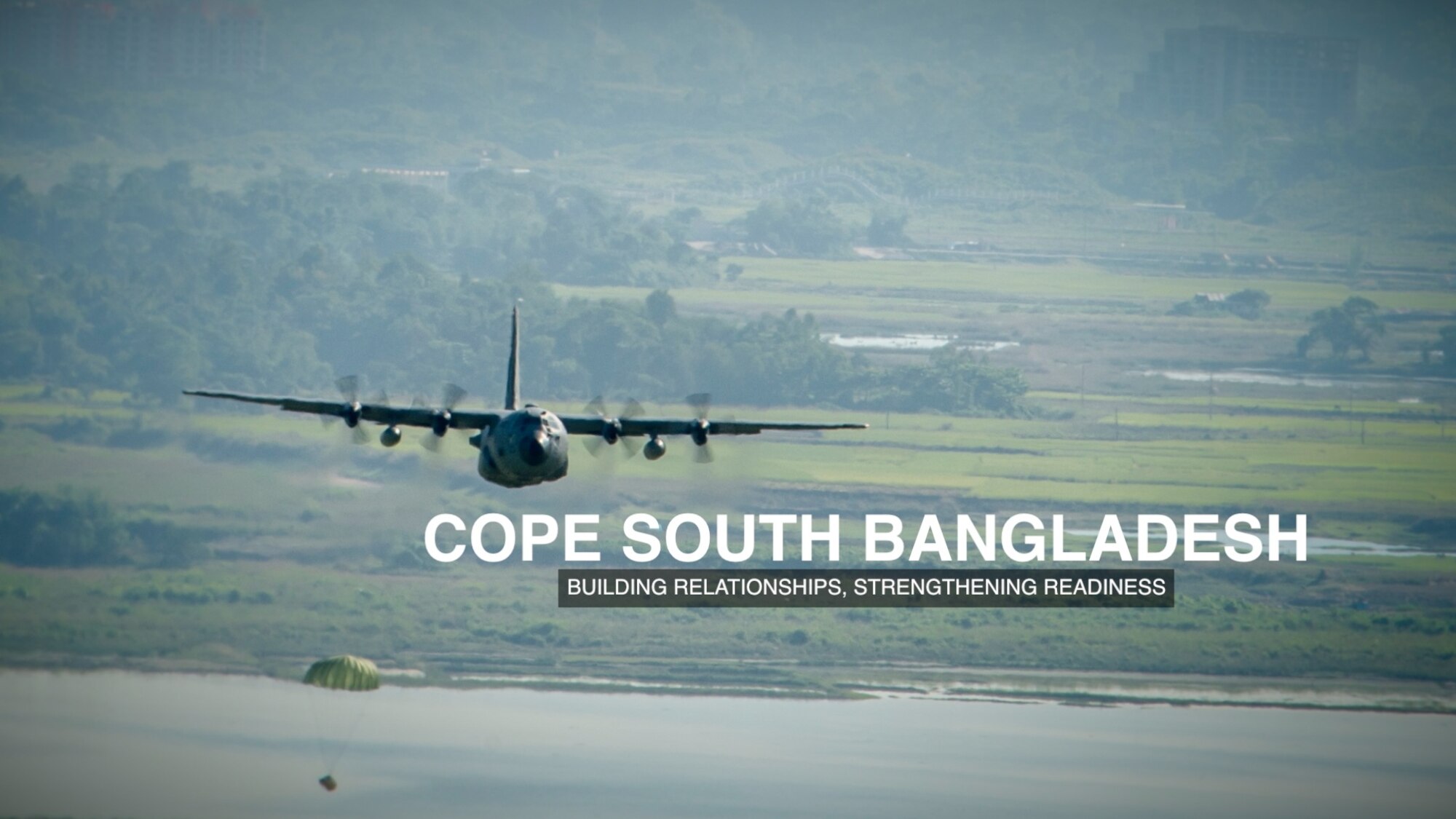 A Yokota C-130 Hercules drops a Low-Cost, Low Altitude bundle during exercise Cope South over Bangladesh, Nov. 9, 2013. The exercise cultivated common bonds, fostered goodwill, and improved readiness and compatibility between members of the Bangladesh and U.S. Air Force. (U.S. Air Force photo graphic by Captain Raymond Geoffroy/Released)
